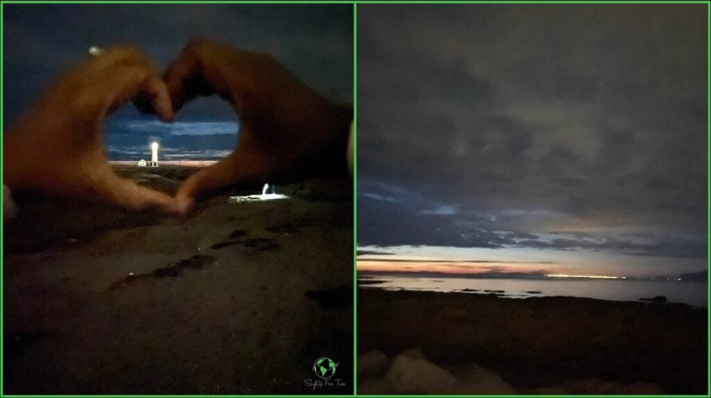 A two-panel image capturing a nighttime scene by the sea: Left Panel: Two hands form a heart shape, framing a distant lighthouse glowing against a dark, moody sky. The scene is intimate and serene, with the lighthouse light cutting through the night. Right Panel: A view of the coastline under a dark sky with faint city lights visible in the distance. The horizon glows softly with the last light of dusk, reflecting off the calm water.