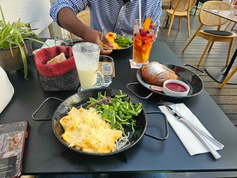 Man eating at table, Scrambled eggs ,croissants