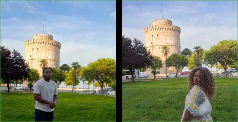 Couple posing for picture in front of white tower
